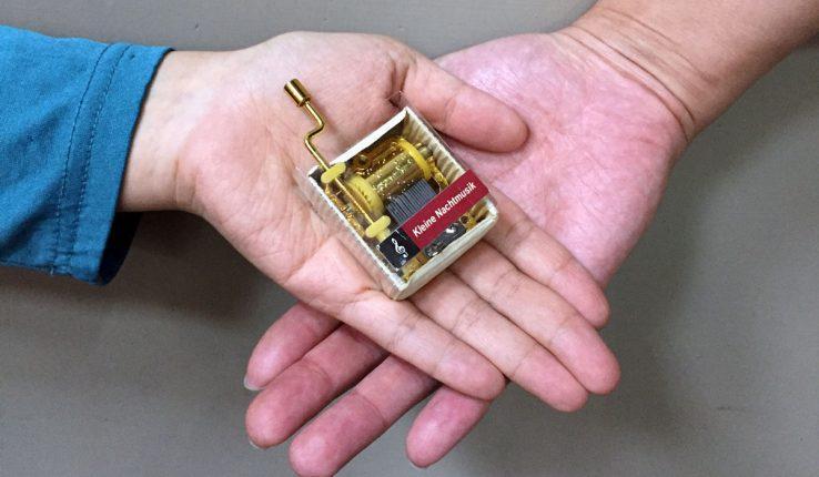 programmable music box Muro Box - the founders holding the music box in their hands