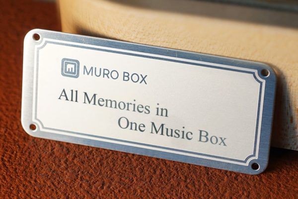 Showcasing the custom laser in engraved Times New Roman font on the Muro Box, the world first app-controlled music box