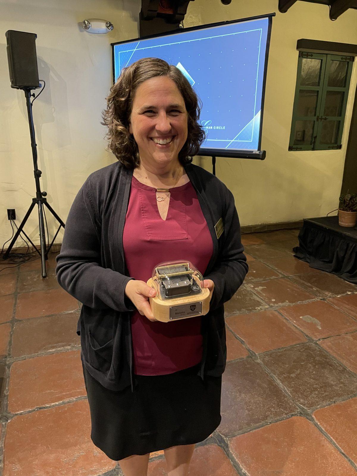 Wendi is holding Muro Box in alumni gathering of University of Rochester (UofR)