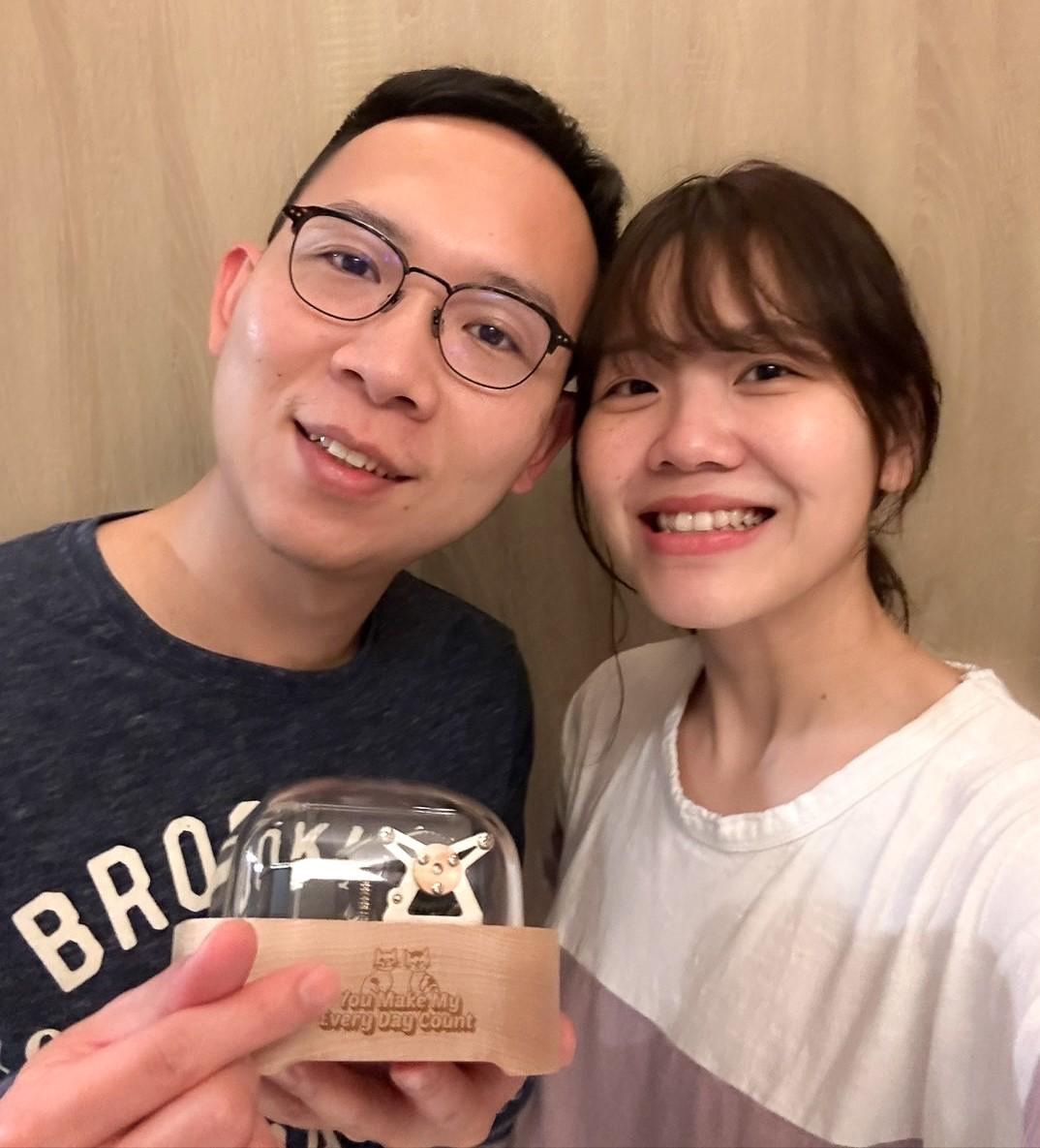 Joy and her hushand and their customized music box (Muro Box) with special engraving design and their special love songs.