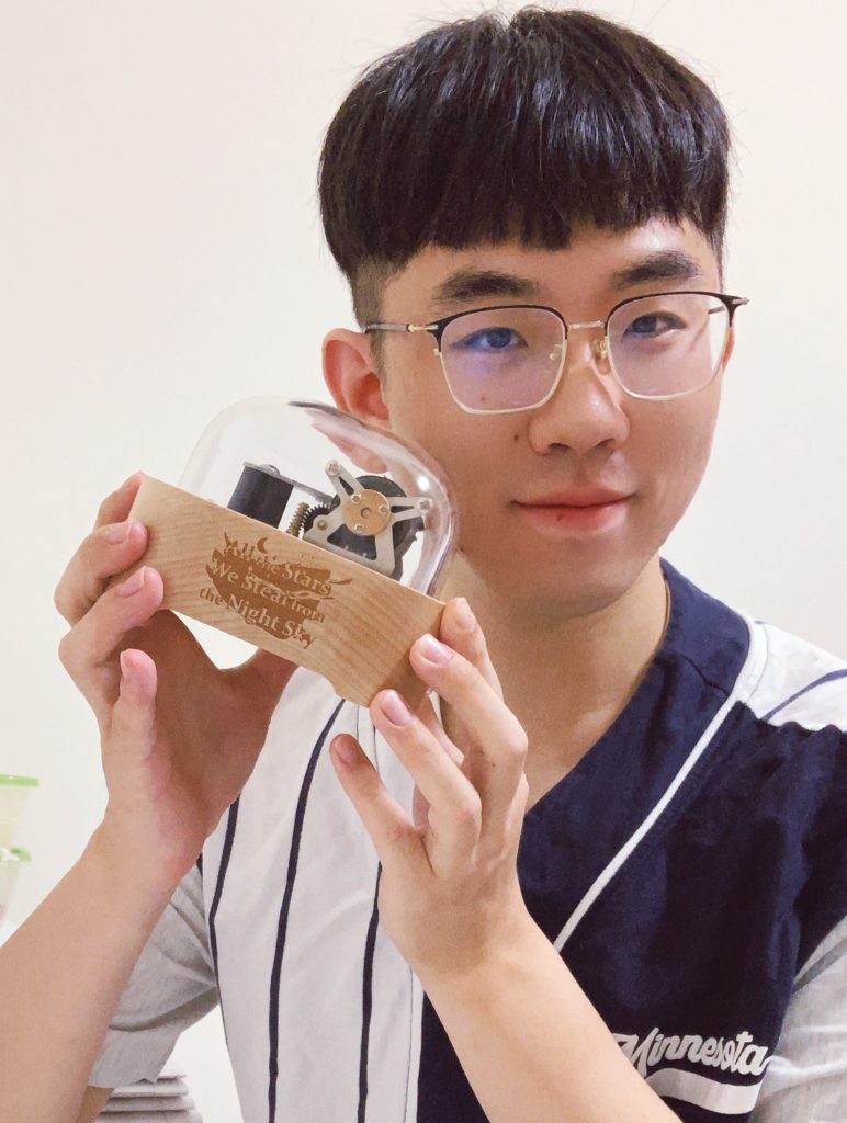 Doctor Huang and his Muro Box(music box) with his customized laser engraving design on the wooden box.