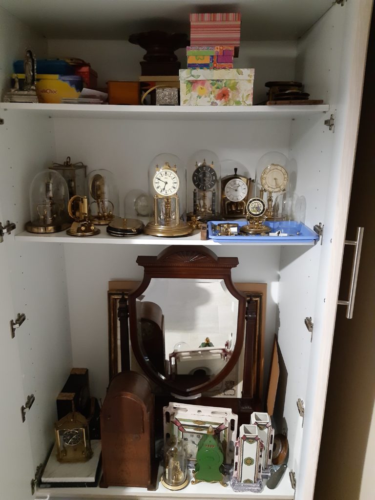 My closet of “projects to come”. I am in the anniversary clock phase. (You only need to wind it up once a year.) On the highest shelf you will find music box movements in every box.