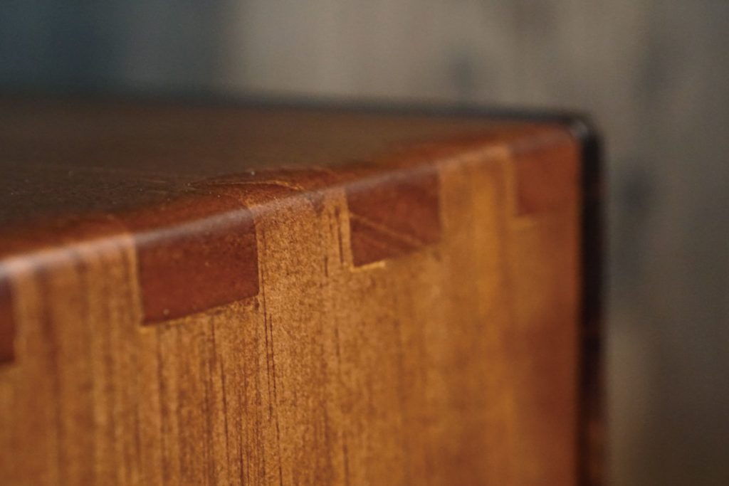 This is a close shot of pinewood grain and its joint design of the resonance box after adding black walnut color lacquer paint.