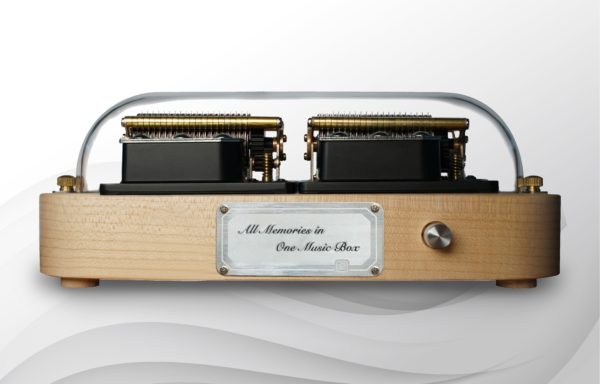 The front side of Muro Box-N40 Standard music box shows a metal plate for adding customized engraving content and a knob for selecting songs to play offline.