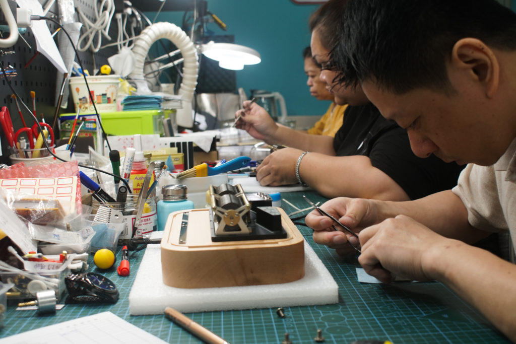 We have three full-time production line operators in house now, the man on the right is our senior operator (Mr. Tsai), and he is in charge of the sound quality of the music box after assembling its components carefully.