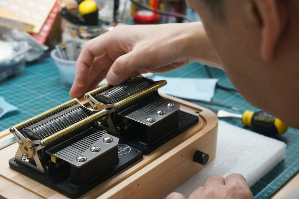 Mr. Tsai skillfully plucks the pins on our patented cylinder of the Muro Box-N40 Standard music box, carefully listening to ensure each note produces the correct sound without any abnormalities