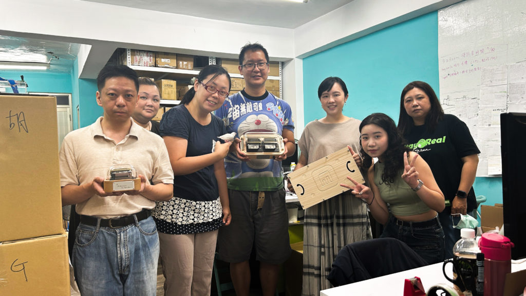 The photo was taken at Joeri's request for a picture of our team members with the N40 product he purchased. From left to right: Mr. Tsai, our senior operator, is holding the N20 standard version.Behind him is Ms. Zeng, our newly trained production operator. Co-founder, Dr. Shiao-Chen Tsai is holding a java sparrow.The inventor of the product, Dr. Chen-Hsiang Feng, is holding the N40 music box. Our music arranger, Ms. Liu, is holding the pine resonance box. Our engraving designer, Ms. Chiu, is making 2 YA hand gestures. On the far right is Ms. Guo, our administrative staff member in charge of shipping arrangements.