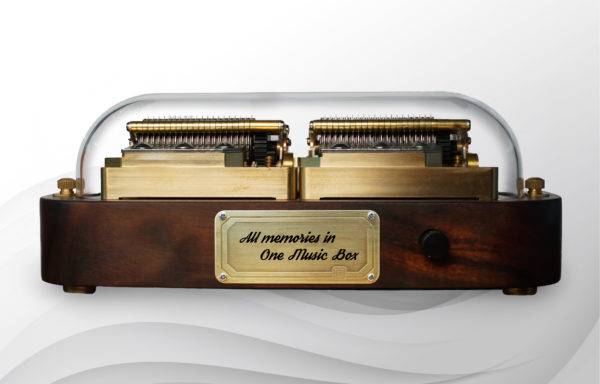 The front side of Muro Box-N40 Sublime music box shows a metal plate for adding customized engraving content and a knob for selecting songs to play offline.