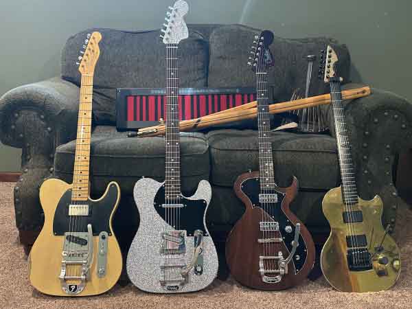 This photo contains several of the instruments I use to create music. From the front left there is a 50s reissue Fender Telecaster, a fully custom bass 6 made by a friend (viewers will notice that the silver guitar has a longer neck than the guitars on either side, a bass 6 is a guitar tuned 1 octave lower), a custom guitar made for me by Creston Lea of Creston Guitars, this guitar is called the Sinister 6, and finally to the right an aluminum bodied guitar with a magnesium metal neck made by Arndt Anderson. In the back is a Haken Continuum (the black box with red and black lines), an Atlansia Solitaire single string fretless bass (designed by Nobuaki Hayashi, also known as H. Noble in Japan), and to the back far right, a waterphone.